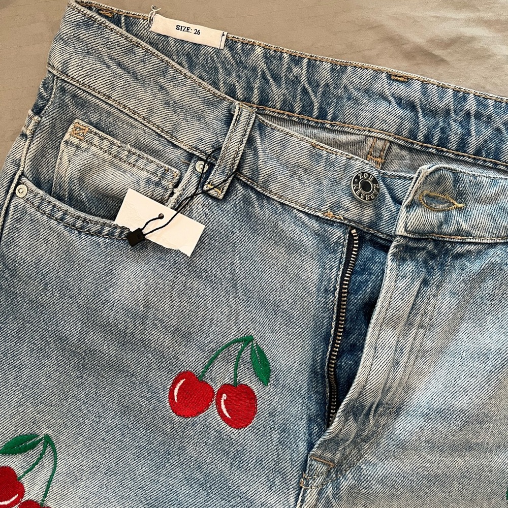 Super cute jeans with cherries on front!